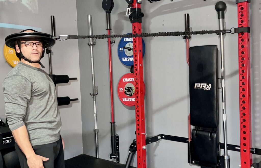 shredded dad using the iron neck 3.0 pro