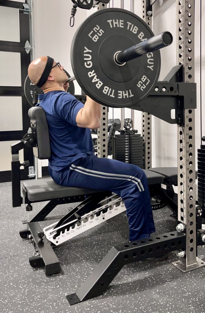 seated military press with the apex stryker pad